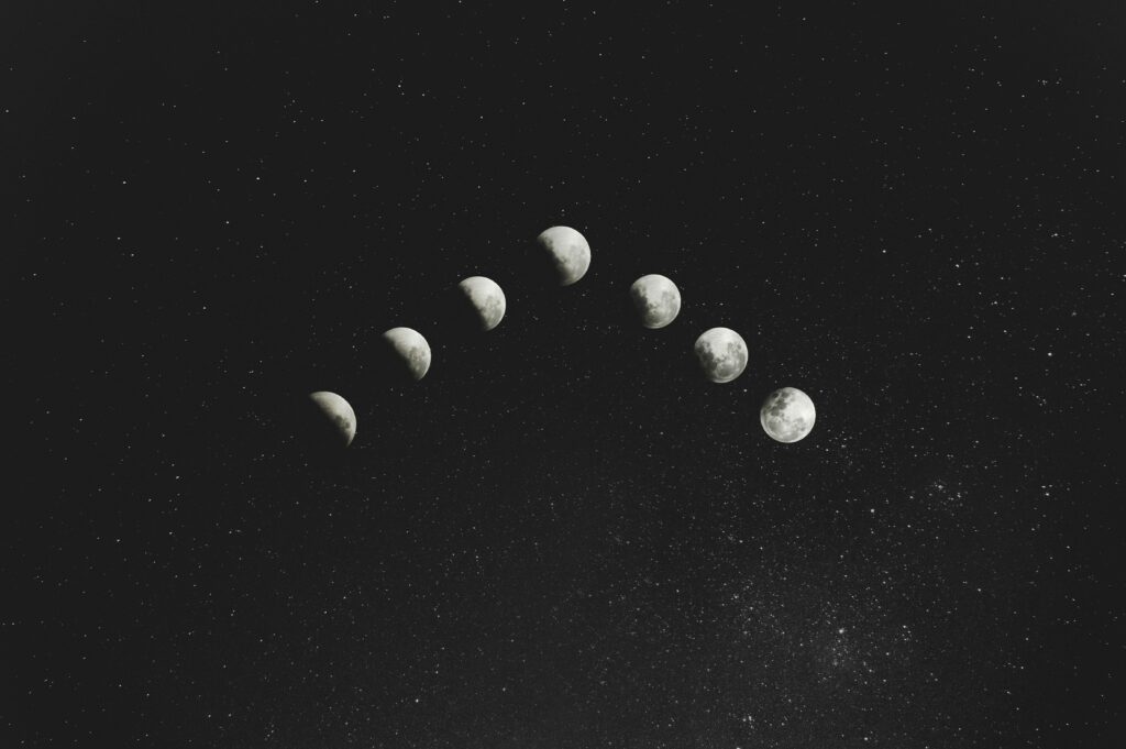 The seven phases of the moon in a star-filled black sky 

Photo by Anderson Rian on Unsplash